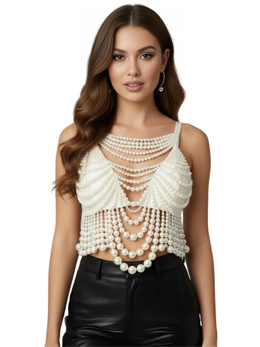 Woman wearing a white pearl top and black leather pants on a white background